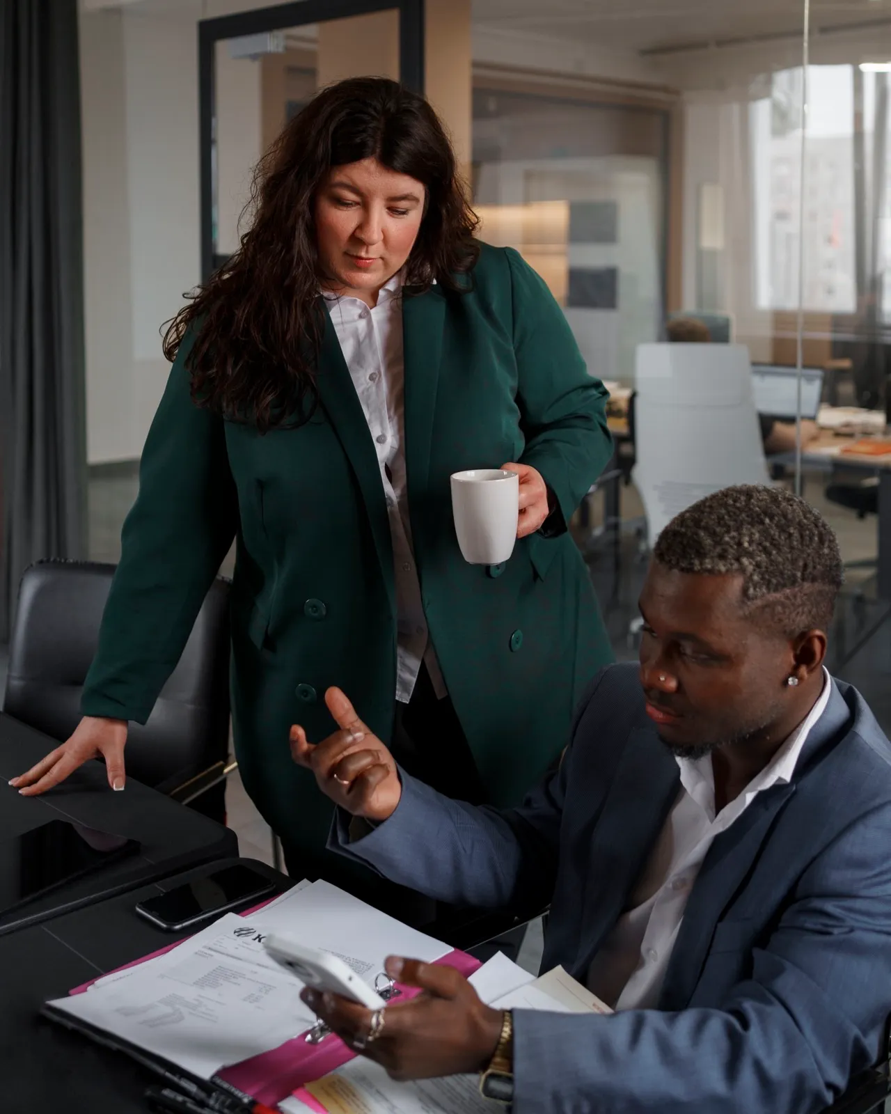Two people discussing next steps together in an office