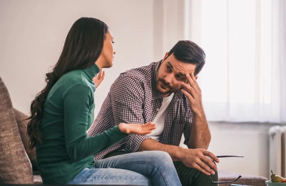 Couple having a serious conversation at home, discussing relationship or separation decisions.