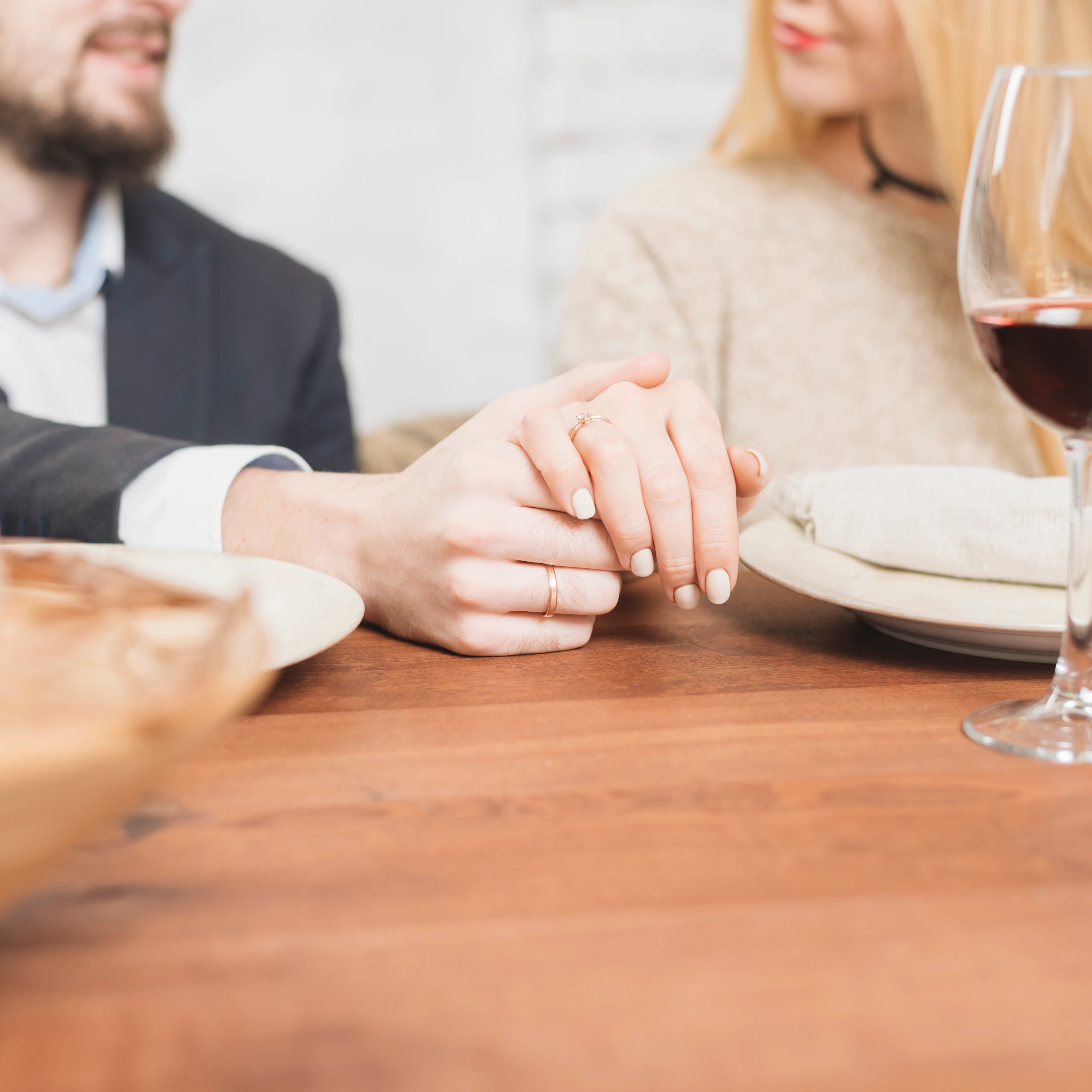 couple-holding-hands with wedding rings