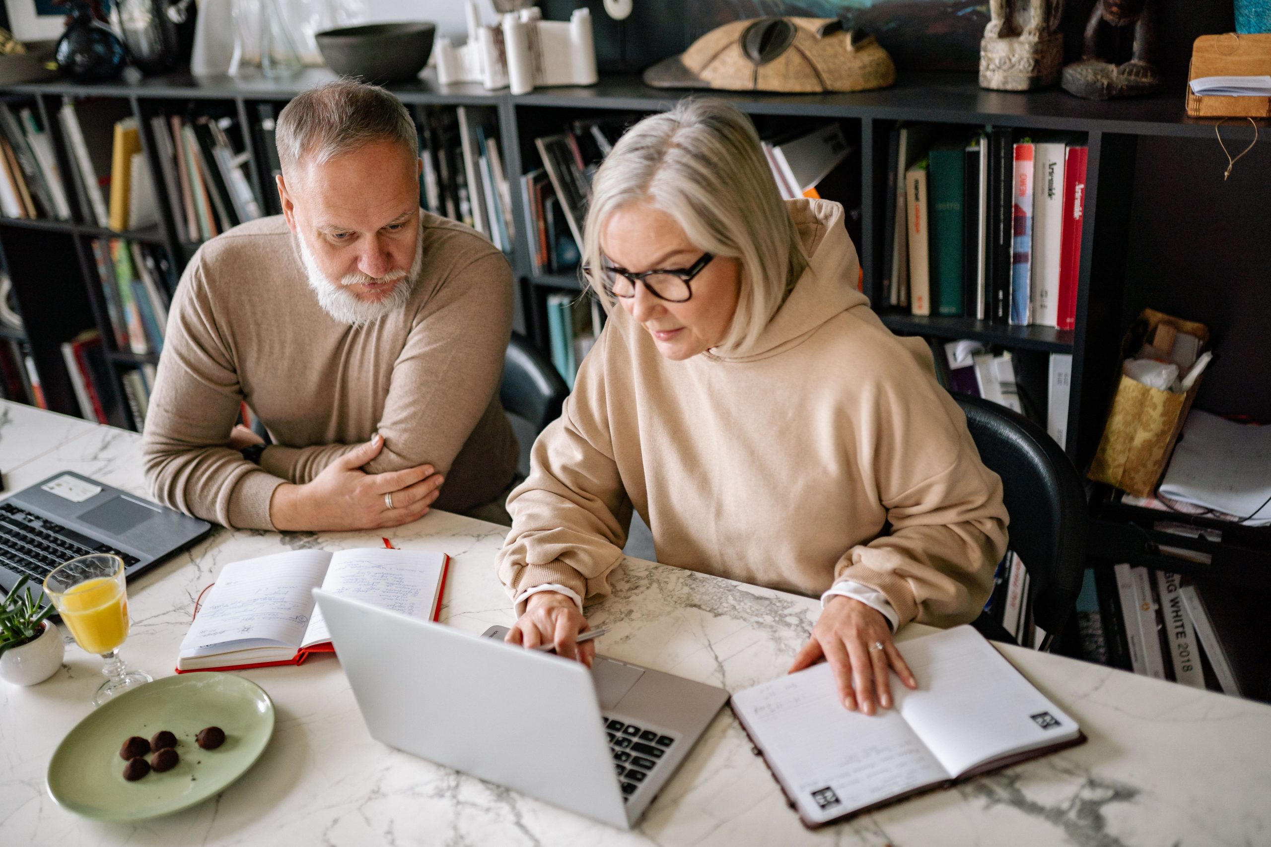 Couple reviewing financial paperwork at home as part of financial planning for divorce in midlife